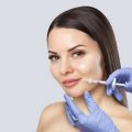 There is a woman, who is making the Lips augmentation procedure  in a beauty salon.Cosmetology skin care.